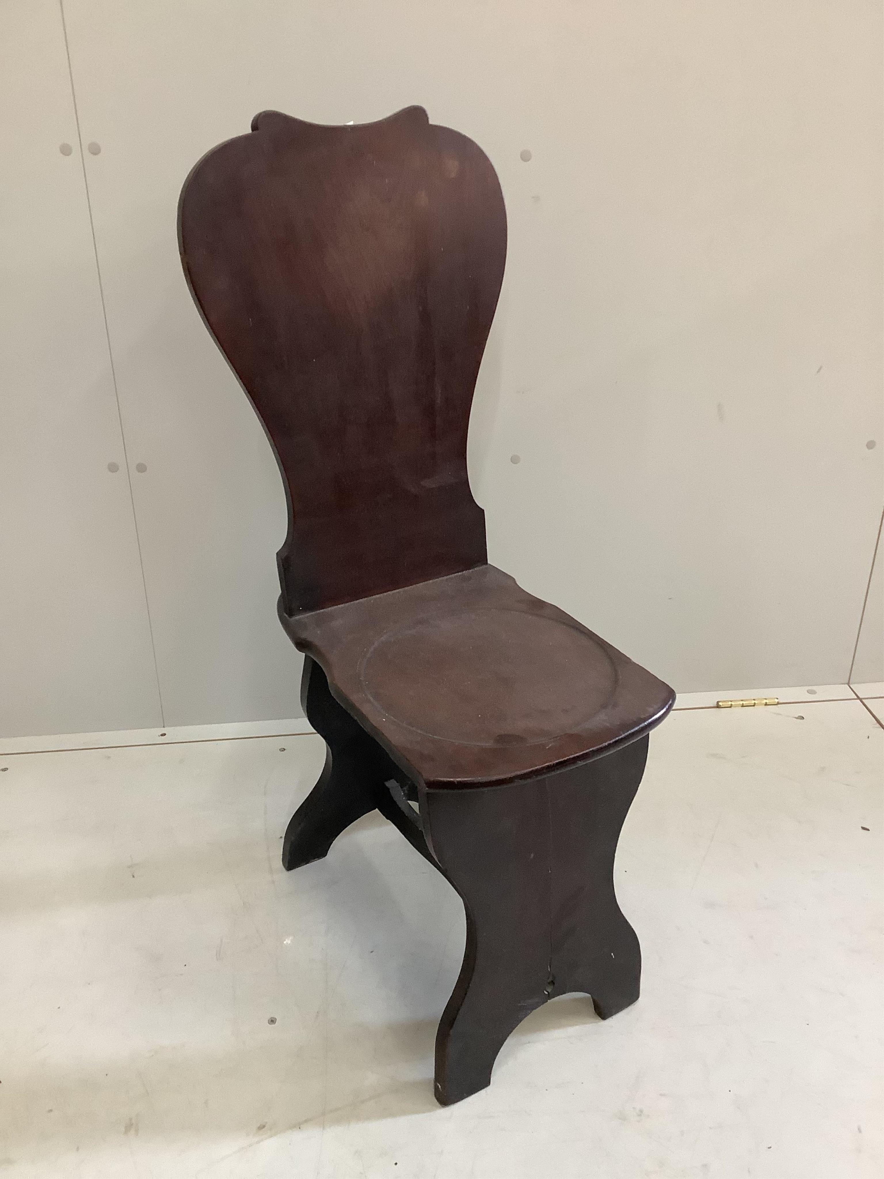 A George III Cuban mahogany hall chair, height 94cm. Condition - fair